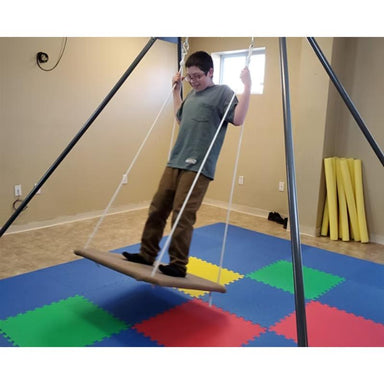 child swinging on Take a Swing HPSI portable therapeutic swing frame