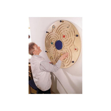 Woman interacting with the Haba Pro Labyrinth Wall Game