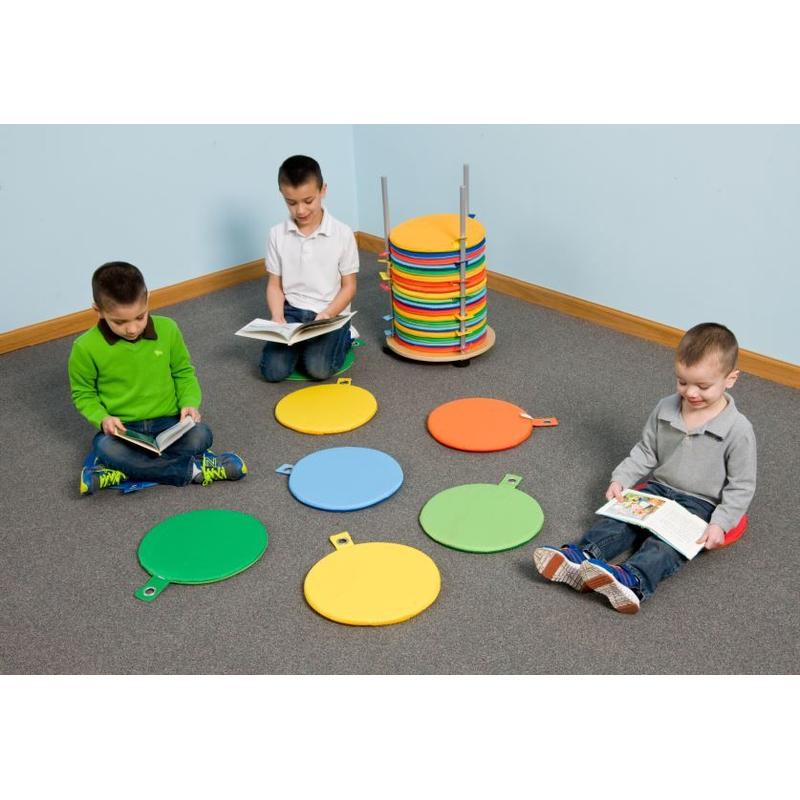 Children sitting on colorful circular cushions of the Haba Pro Seat Cushion Carousel 