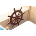 Wooden toy ship with a brown steering wheel on a white background