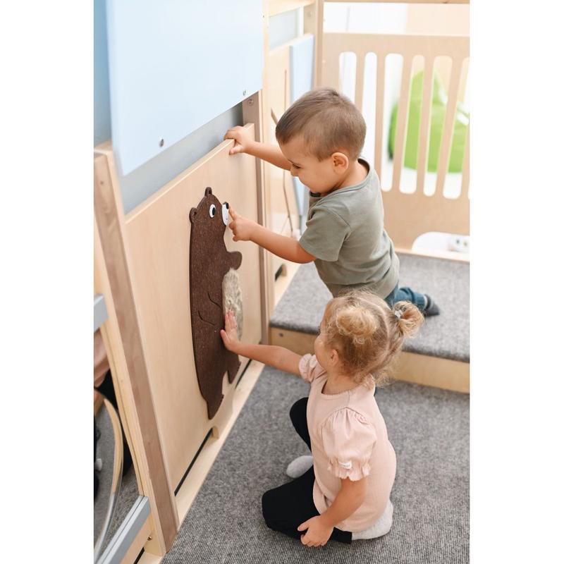 Two children interacting with a wooden panel featuring a bear cutout in the Moje Bambino Summit Toddler Play Loft
