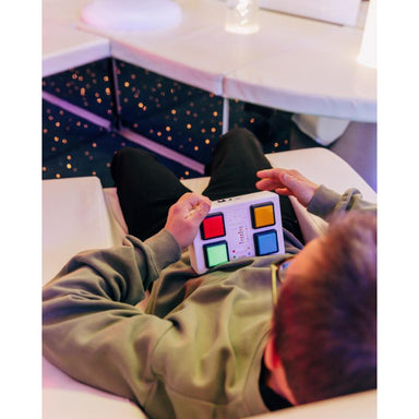 Child holding the TFH 4 Button Wired Color Controller