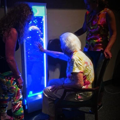 3 persons in front of a TFH Bubble Wall 60" with blue light