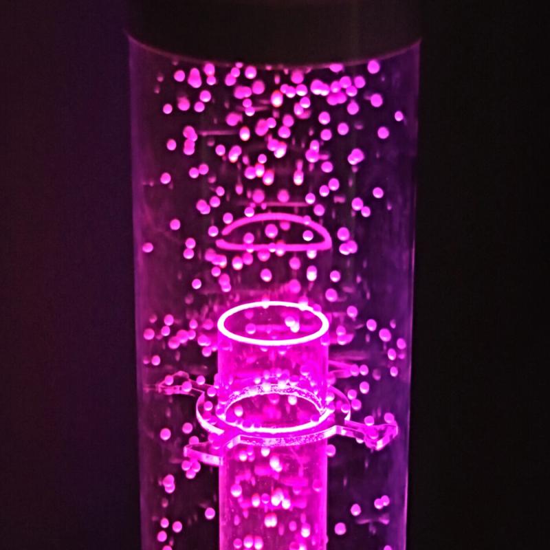 TFH Calming Hurricane Tubes with pink light in dark sensory room