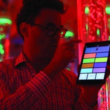 Person holding tablet with Color Control connected to TFH Combination Wireless Genie Receiver