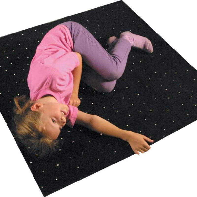 Child lying on TFH Fiber Optic Starfield Carpet