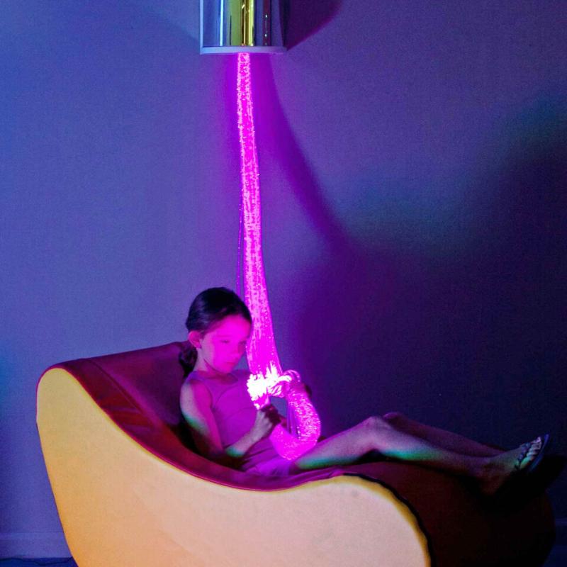 Girl sitting in chair with TFH Fiber Optic Wall Sconce with Tails hanging from ceiling