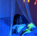 Girl lying under TFH Fiber Optic Waterfall in dark sensory room