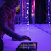 Child playing with TFH Genie Bubble Tubes and controller