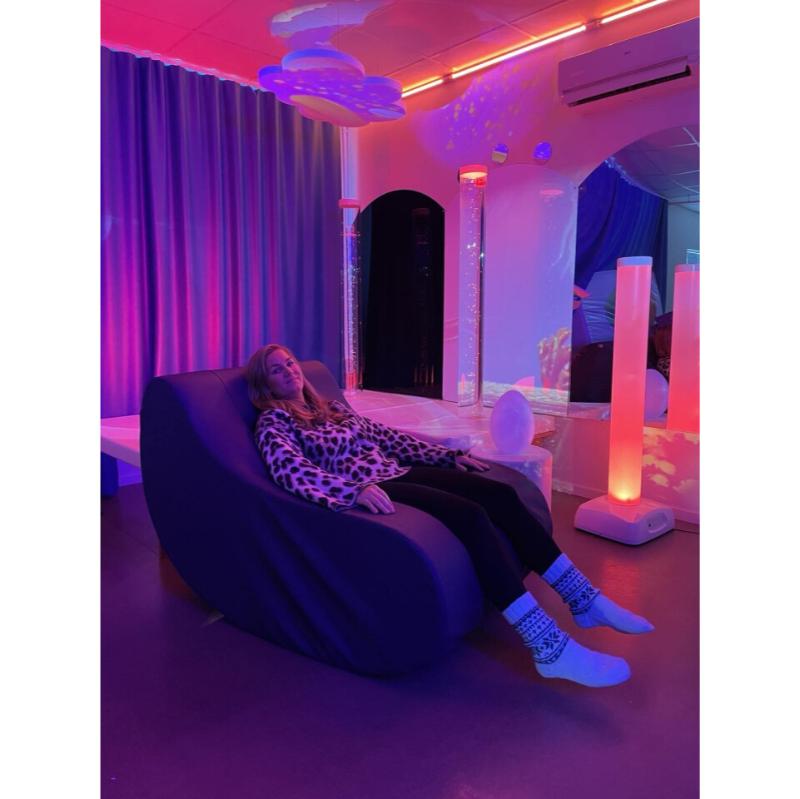 woman in sensory chair in a room with TFH Genie Color Wash Kits