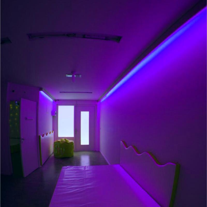 TFH Genie Color Wash Kits in room with purple lighting with sensory bed