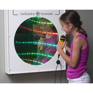 Child using a microphone in front of an TFH Infinity Tunnel mirror with LED lights.