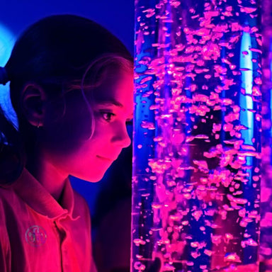 girl looking at TFH Interactive Bubble Tubes with pink and blue lights