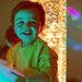 Small boy laughing in front of TFH Interactive Bubble Tubes with yellow lights