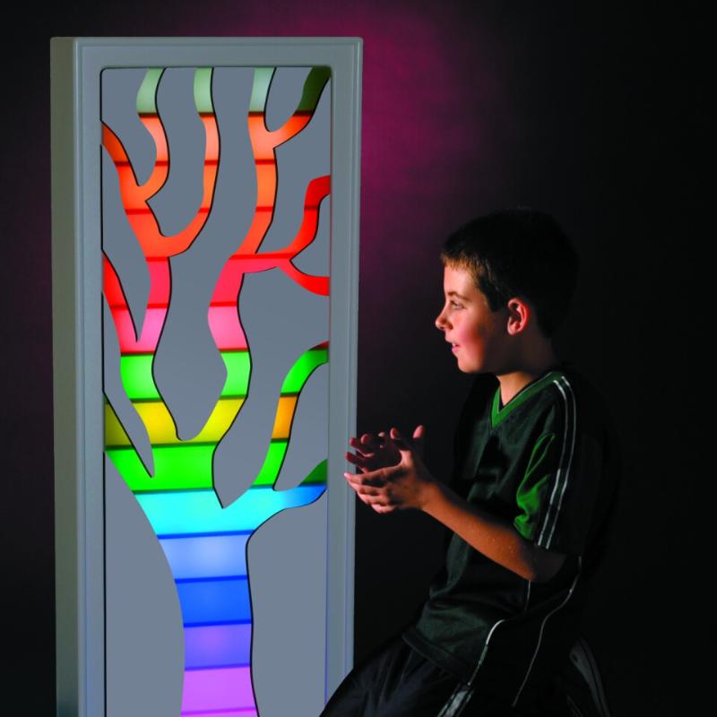Child sitting in front of the TFH Ladder Lights with a mask of a tree