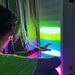 Person interacting with TFH Ladder Lights in blue and yellow light setting