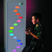 Child sitting in front of the TFH Ladder Lights with Ladder mask showing various colorful wholes