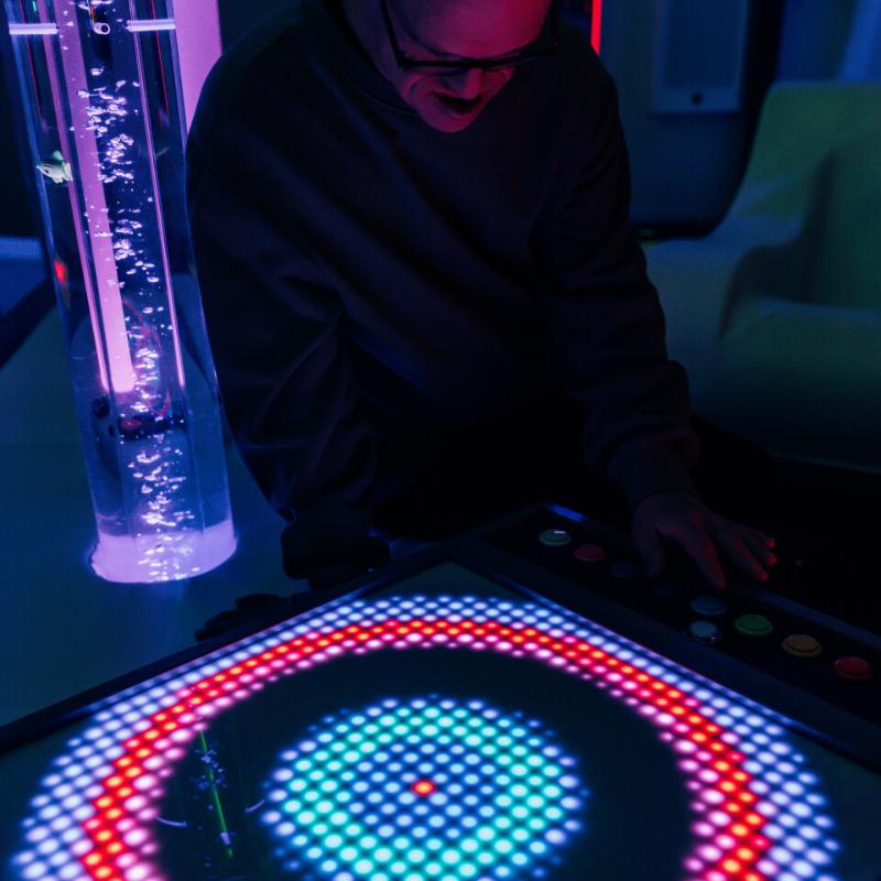 person interacting with the TFH Pixels Pro Interactive Panel with circle grow and fade mode