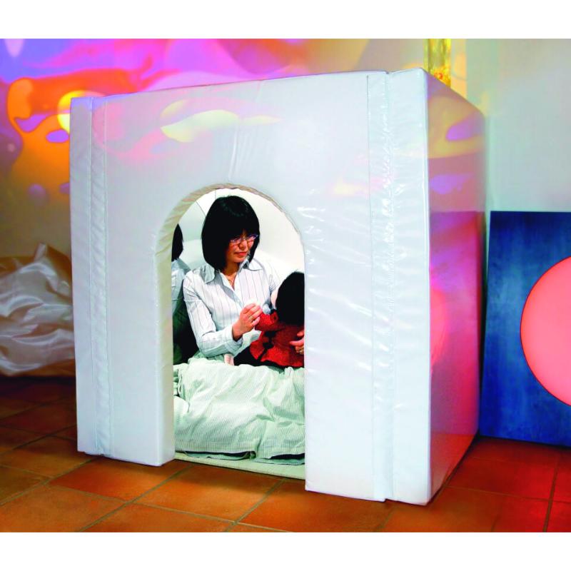 Woman with a doll sitting inside a TFH Portable Sensory Den with colorful projections on the wall