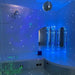 TFH Quadrant Podium Bench in a sensory room with bubble tubes, fiber optic sprays and a disco ball