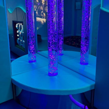 TFH Quadrant Tube Podium with a bubble tube in blue lighting and mirrored walls
