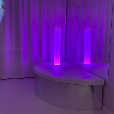 TFH Quadrant Tube Podium with frosted tube in room with white curtains and floor and mirrored walls