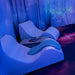 Two white TFH Relaxer Chairs in a sark sensory room setup