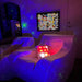 TFH Rod Wall Light Panel hanging on the wall of a sensory room with 2 loungers