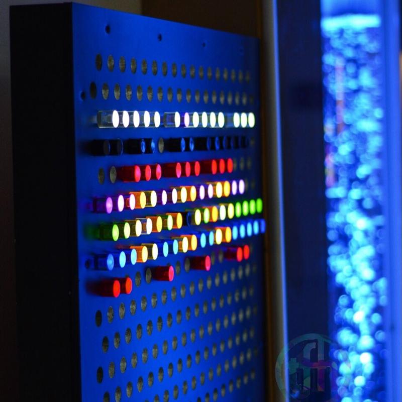 TFH Rod Wall Light Panel  in dark sensory room setup with bubble tube in the background
