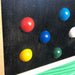detail of the TFH  Tactile Columns with colorful balls on black background