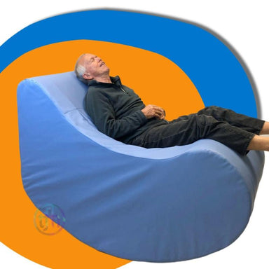 Man lying on a TFH Therapy Chair with blue and orange background