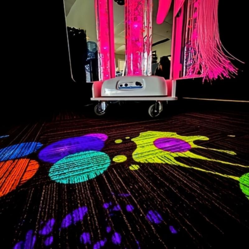 TFH Vecta Budii Mobile Sensory Station with pink lighting projectoing colorful images to dark floor