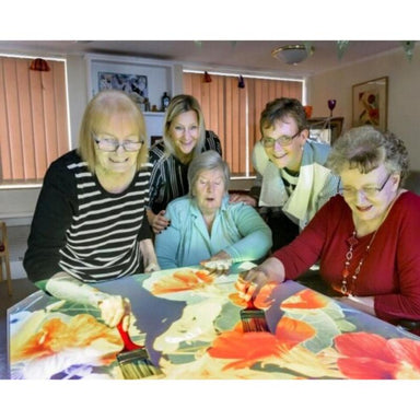 Groups of seniors playing with a projection of the TFH Vecta Budii Projector