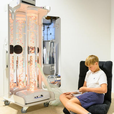 Boy sitting in front of a TFH Vecta Deluxe Mobile Sensory Station