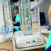 child interacting with a TFH Vecta Deluxe Mobile Sensory Station with colorful bubbles in the tube
