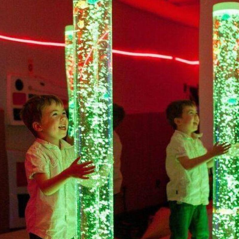 children playing with TFH Wireless Bubble Tubes with green lighting