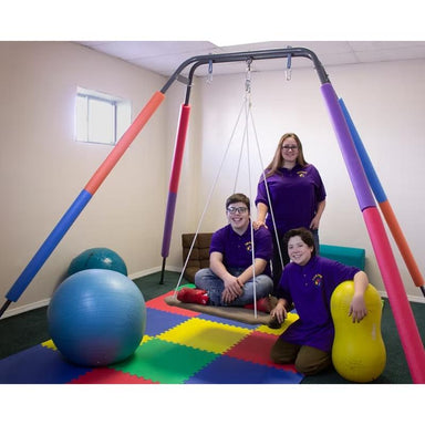 three people testing the Take a swing Homestand II portable therapeutic swing