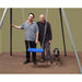 2 men and a dog behind a Take a Swing SwingALL portable therapeutic swing with blue seat